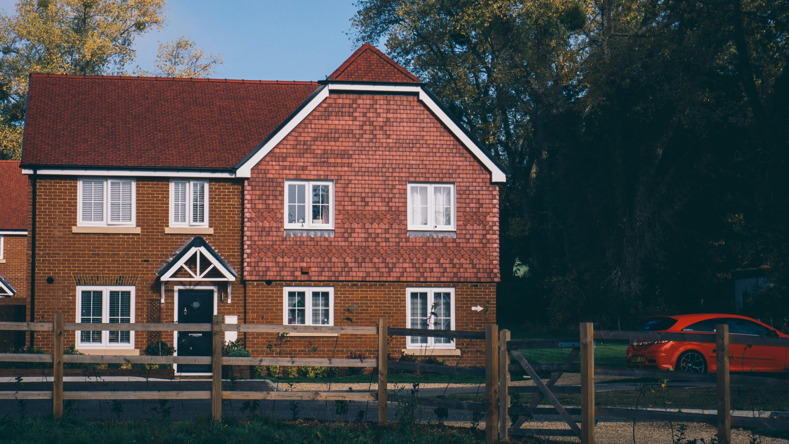 Quaint English family home with red brick and car in Farnham.