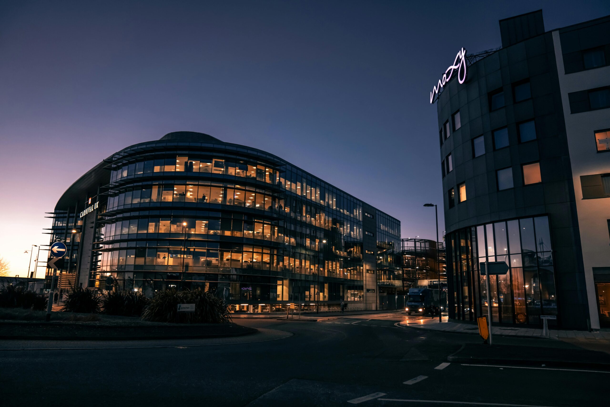 A sleek, modern office building illuminated at night in Southampton city center.